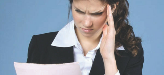 Stressed out accountant reviewing documents