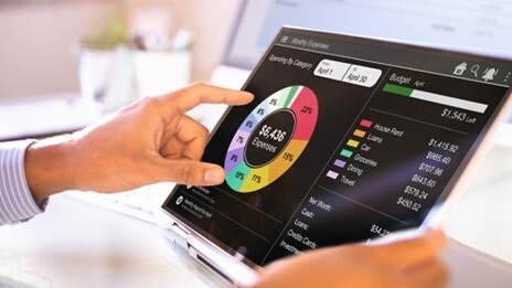 Graph on laptop reviewing a client's contribution to the firm